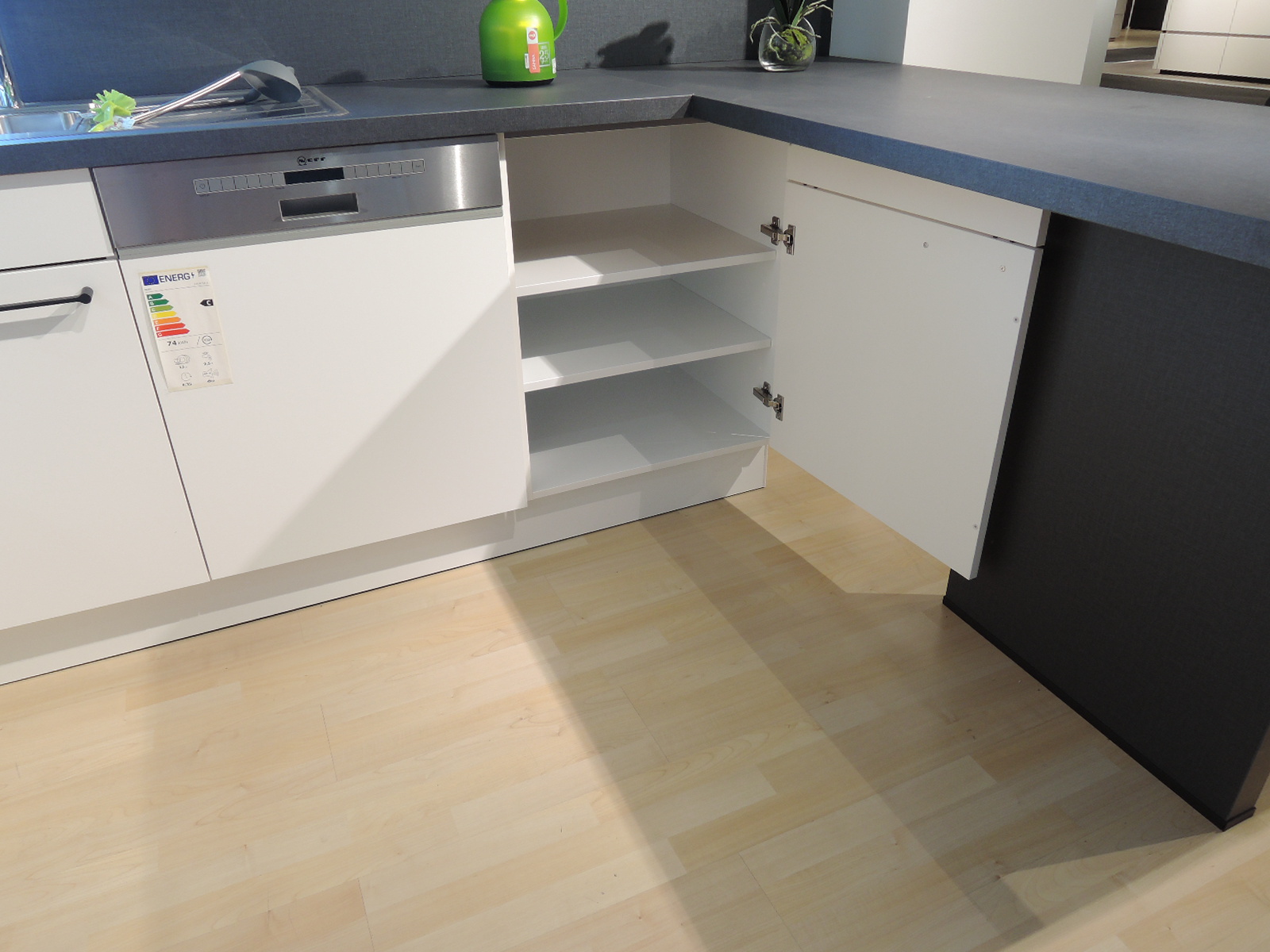 Blick in den geöffneten Unterschrank rechts vom Geschirrspüler